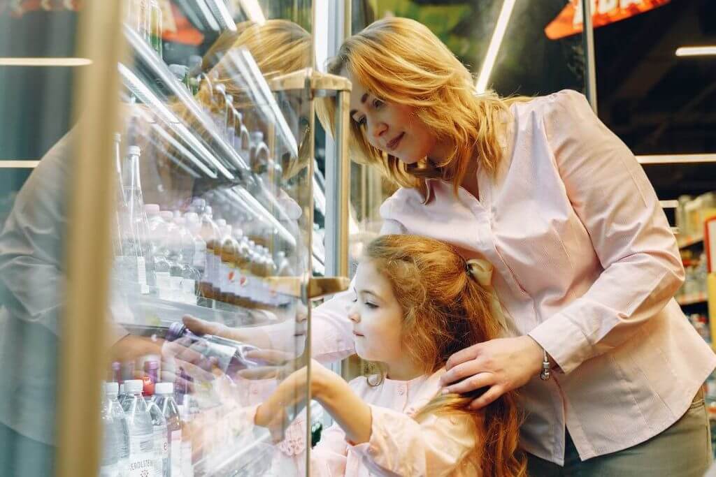 woman and child reaching in to commercial refrigerator