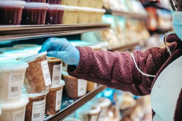 person grabbing frozen product from commercial freezer