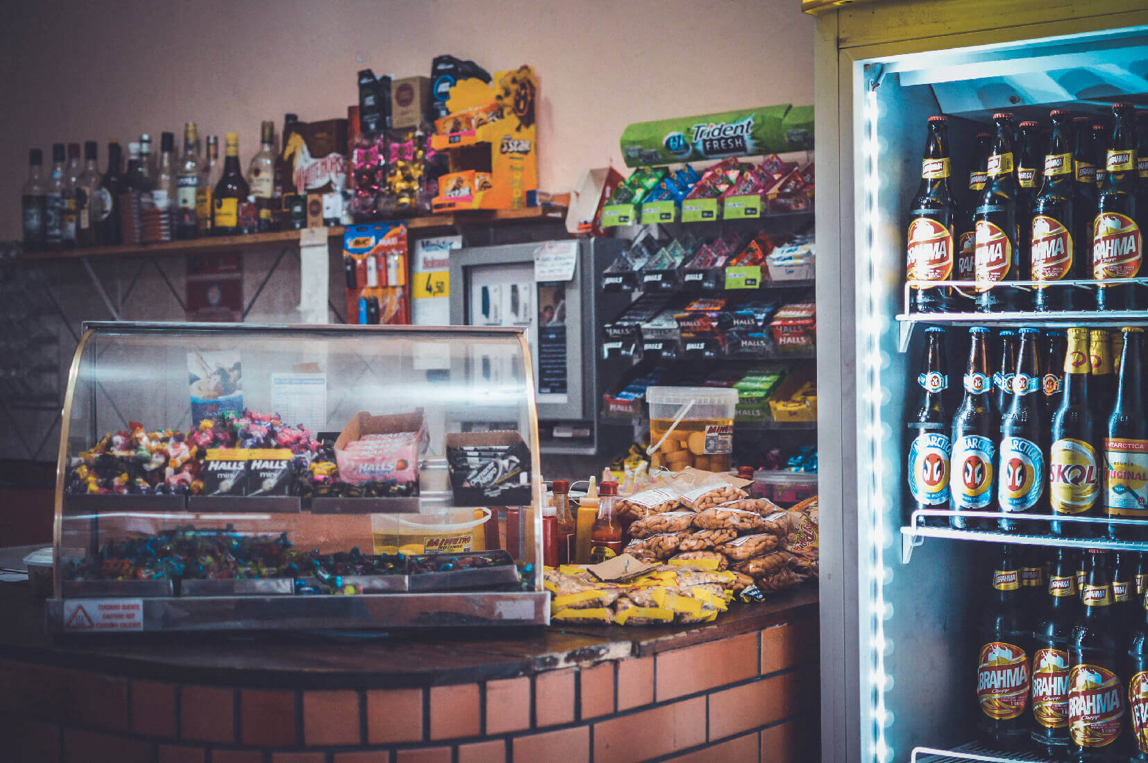 merchandiser fridge next to counter in convenience store