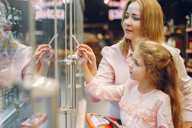 business owner and her and daughter going through fridge maintenance checklist