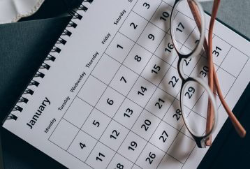 glasses resting on a paper calendar