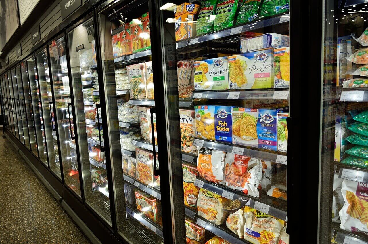 Grocery store freezer with frozen food inside